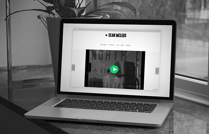 A-laptop-featuring-a-video-website-design-elements