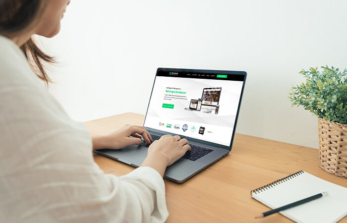 A-woman-scrolling-a-website-on-laptop-website-design-elements