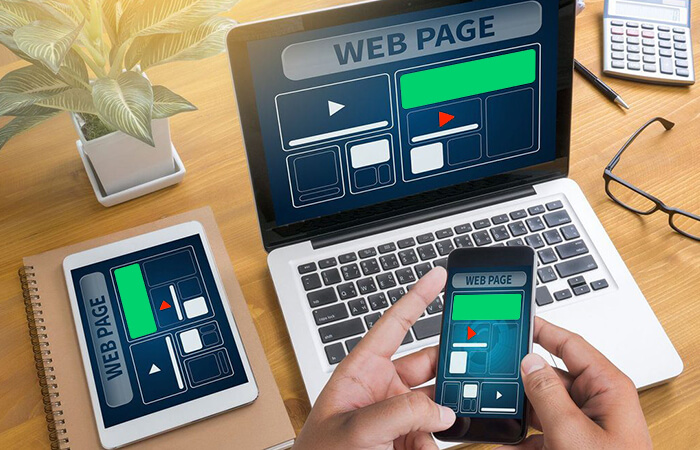 A-person-using-a-laptop-and-mobile-device-website-design-elements