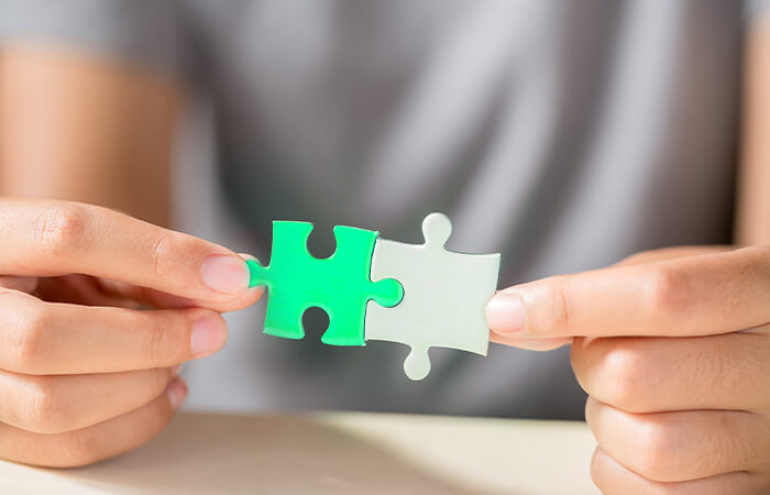 A-hand-connecting-two-puzzle-pieces